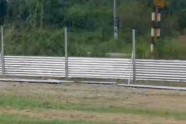 Flat land beside KL-Ipoh Trunk Road near Komuter