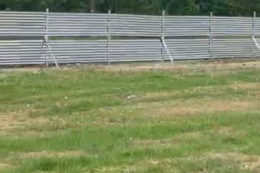 Flat land beside KL-Ipoh Trunk Road near Komuter